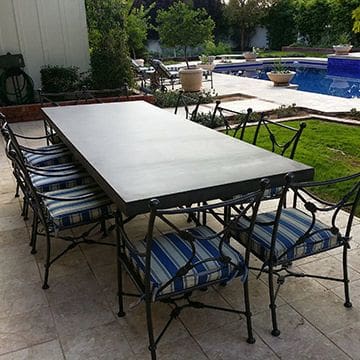 A table and chairs set up in the middle of an outdoor patio.